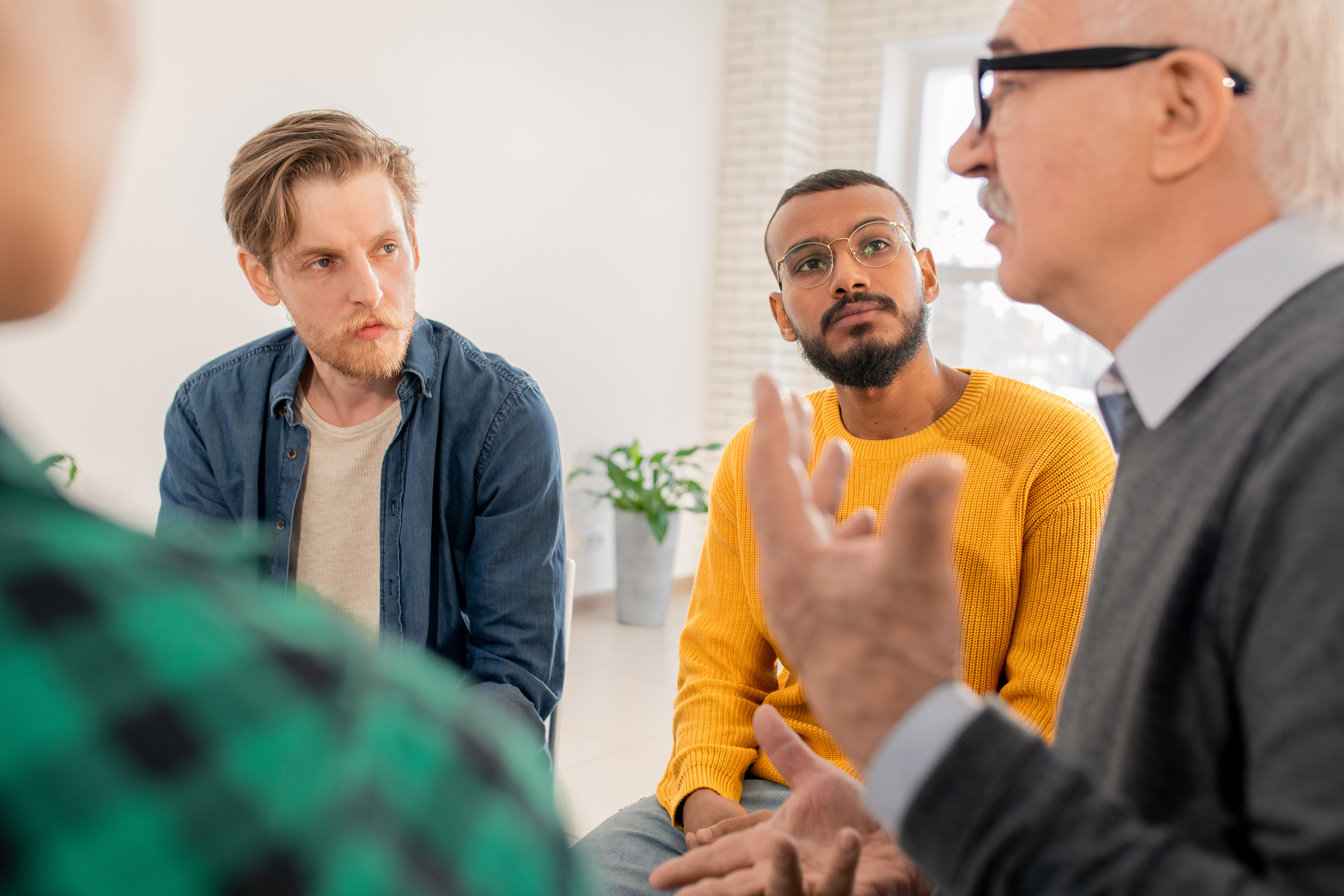 Image of a males group counselling session. You can meet with people going through the same things as you in group therapy in Sherwood Park and Edmonton, AB.
