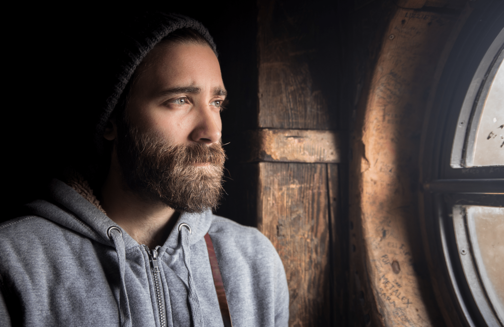Image of a man in a grey hoodie looking out a window. Are you looking for a depression counsellor in Alberta? We offer several depression treatment options in Sherwood Park, AB. With the help of depression counselling you can finally start feeling better. Call today!