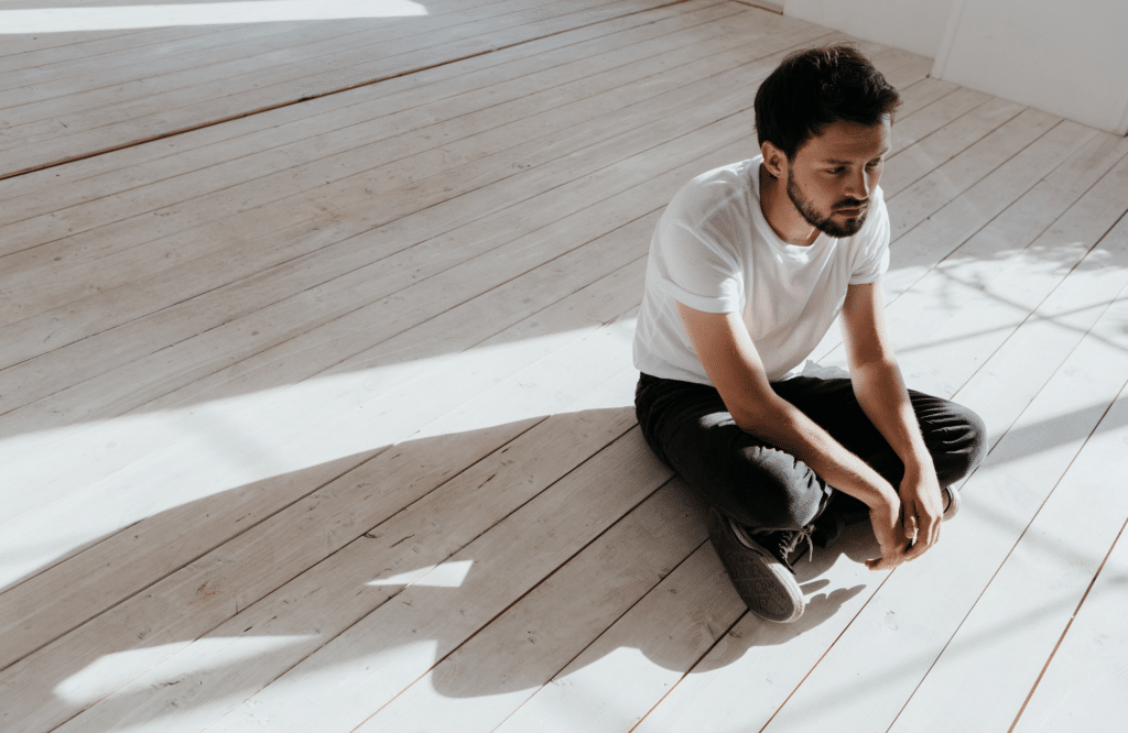 man sitting alone feeling isolated