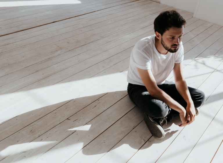 Image of a man sitting alone feeling isolated by trauma without Edmonton PTSD treatment and trauma therapy. A trauma therapist can help you start connecting with your loved ones again through PTSD treatment in Sherwood Park, Alberta.