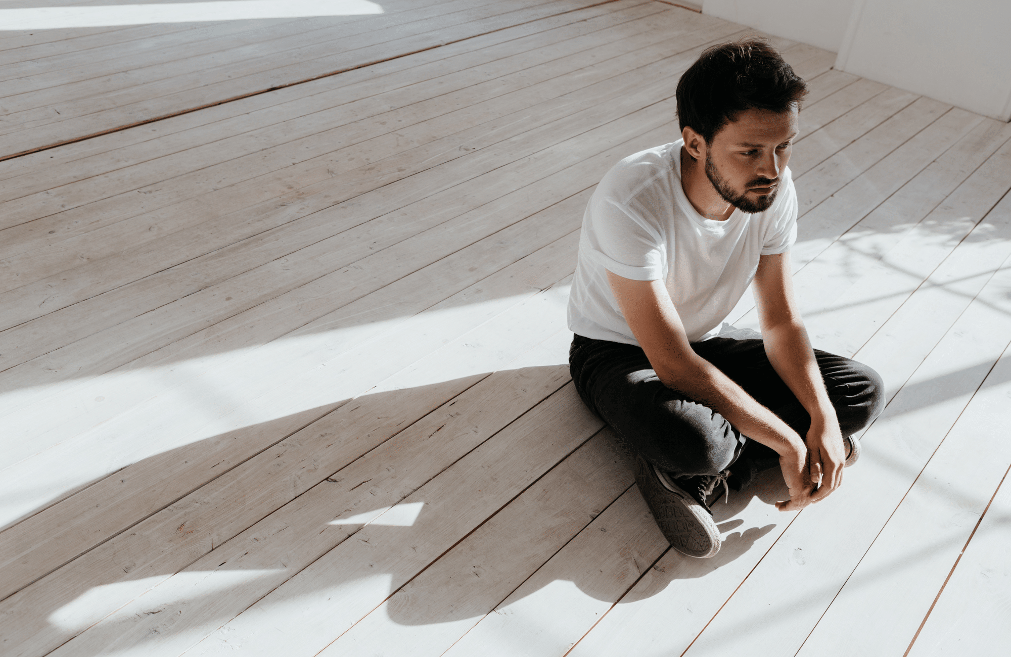 Image of a man sitting alone feeling isolated by trauma without Edmonton PTSD treatment and trauma therapy. A trauma therapist can help you start connecting with your loved ones again through PTSD treatment in Sherwood Park, Alberta.