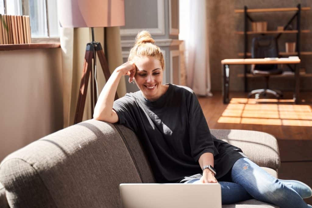 Image of a woman sitting and looking at her laptop. No matter your families needs we can help with online counselling. Our online therapists are trained in many different areas. Start your mental health journey with online therapy in Alberta. Reach out today!