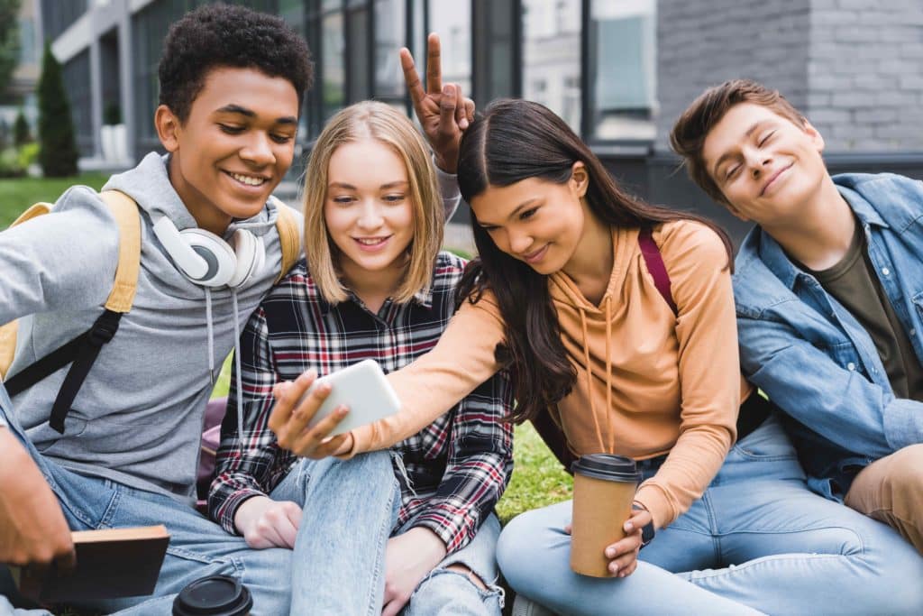 Image of 4 teenagers taking a photo together. Teen therapy can help the mental health of your child. Counselling for teens is specifically tailored to them. Reach out now to connect with a therapist for teens in Sherwood Park, AB T8H 0K4.