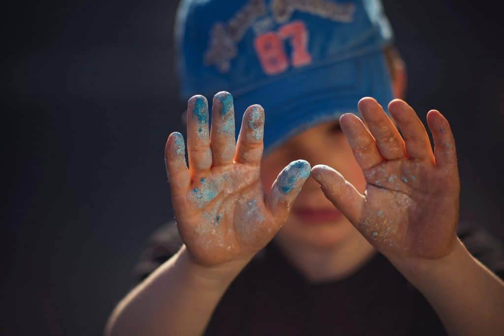 Child with paint in hands
