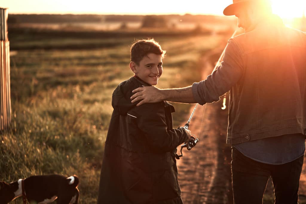 Image of a father and son walking together on a farm with a dog. A family therapist can help you build better communication in your family. Family counselling is about helping each member adjust to changes within the family. No matter what your family looks like we can help you with family therapy in Edmonton, AB T6R 3R8.
