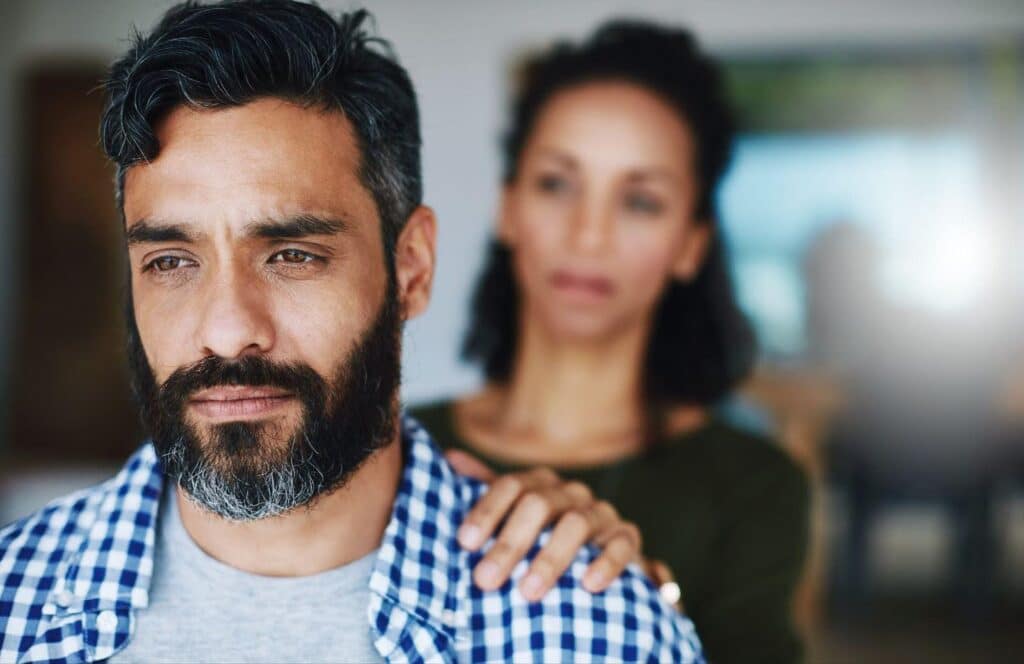 wife holding depressed husband